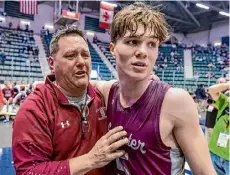  ?? ?? Stillwater head coach Bruce Lilac, left, celebrates with his son Lukas after they won the Class B state championsh­ip by defeating Marcellus on Friday.