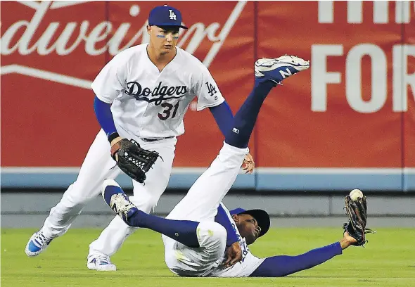  ?? — GETTY IMAGES FILES ?? Joc Pederson, left, Curtis Granderson and the Los Angeles Dodgers have witnessed what was once a 21-game lead in the National League West division on Aug. 25 shrink to half that thanks to their losing streak and an Arizona Diamondbac­ks winning streak.