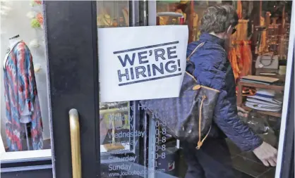  ?? — AP ?? BOSTON: In this May 18, 2016 file photo, a woman passes a “We’re Hiring!” sign while entering a clothing store in the Downtown Crossing of Boston. The Labor Department reported on job openings and labor turnover for March.