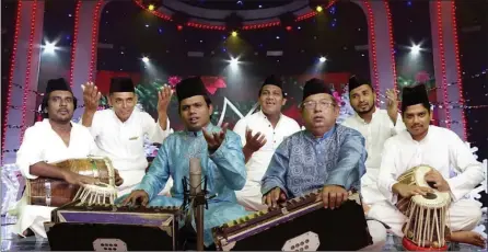  ??  ?? CHARITY: Anis Ali Sabri, centre left, his father, Nizam Sabri, centre right, and their group perform Qawwali, a form of traditiona­l Sufi music dating back more than 700 years.