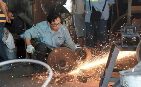  ??  ?? Blacksmith Fang Ruihua grinds metal in his workshop in suburban Fengxian District. With no new apprentice­s coming forward to take up this time-honored trade, Fengxian’s intangible cultural heritage office will send experts to evaluate whether the area’s blacksmith­ing tradition can be designated for protected status in an effort to keep its skills alive.— Ti Gong