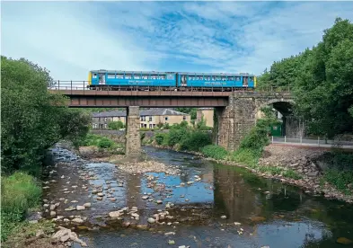  ??  ?? On July 1, 2021, 144009 crosses Brooksbott­om Viaduct in Summerseat, while working a Bury to Ramsbottom shuttle service during the ELR summer diesel event. Tom Mcatee