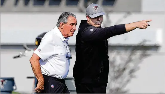  ?? CURTIS COMPTON/AJC 2021 ?? First-year coach Arthur Smith (right) points something out to team owner Arthur Blank during training camp earlier this summer.