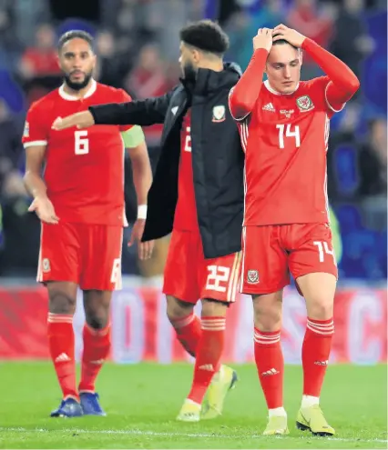  ?? Mike Egerton/pa Wire ?? A disappoint­ed Connor Roberts (right) after Wales’s Nations League defeat by Denmark last month.