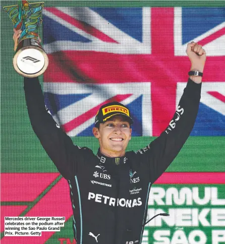  ?? Picture: Getty ?? Mercedes driver George Russell celebrates on the podium after winning the Sao Paulo Grand Prix.