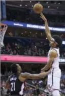  ?? ALEX BRANDON — THE ASSOCIATED PRESS ?? Brooklyn’s Jarrett Allen, right, shoots over Washington’s Dwight Howard during the second half on Friday in Washington. The Nets won, 115-104.