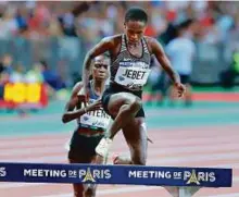  ?? AP ?? Ruth Jebet of Bahrain clears a hurdle to win with a new world record time in the women’s 3,000-meter steeplecha­se event in Paris, France.