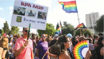  ?? (Marc Israel Sellem) ?? GAY PRIDE parades ‘are not about rights. They’re about waving a flag and saying this is normal.’ Pictured: Jerusalem’s 2018 Pride Parade, with a sign decrying Smotrich (on right of sign) as one of those spreading ‘baseless hatred, bringing down the third Temple.’