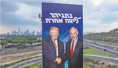  ?? ODED BALILTY/ AP ?? An election billboard plays up the relationsh­ip between Israeli Prime Minister Benjamin Netanyahu and President Donald Trump. In Hebrew, the billboard reads, “Netanyahu, in another league.”