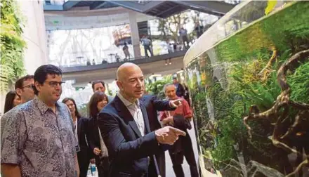  ?? BLOOMBERG PIC ?? Amazon founder and chief executive officer Jeff Bezos (right) touring the Spheres during its opening day in Seattle last month. According to the Wall Street Journal, the company will also like to become a supplier of medical equipment for hospitals.