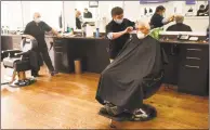  ?? Tyler Sizemore / Hearst Connecticu­t Media ?? Jeff Ramer, of Riverside, gets a haircut from Antonio Merolla at Classic Barber of Greenwich on Monday.