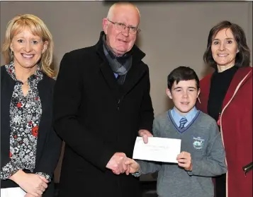  ??  ?? Michael Kirby of Scoil Mhuire gan Smál, Kilkerley, joint second prize winner in the Louth County Council Greener Christmas Poetry Competitio­n receives his award from (L-R) Aisling Sheridan, Louth County Council, Larry Magnier, Louth Tidy Towns Together...