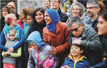  ?? Reuters ?? Democratic congressio­nal candidate Ilhan Omar poses for a group photo with campaign volunteers in Minneapoli­s last week.