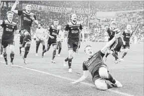  ?? LUCA BRUNO THE ASSOCIATED PRESS ?? Ajax’s Matthijs de Ligt and teammates celebrate at the end of the Champions League quarterfin­al 2-1 victory over Juventus, advancing to the Champion League semifinal on aggregrate 3-2.