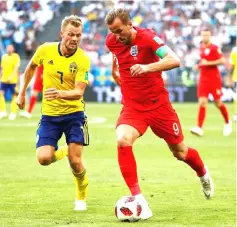  ??  ?? England’s Harry Kane in action with Sweden’s Sebastian Larsson. — Reuters photo