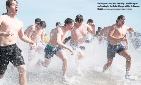  ?? ANTHONY VAZQUEZ/SUN-TIMES PHOTOS ?? Participan­ts run into freezing Lake Michigan on Sunday in the Polar Plunge at North Avenue Beach.