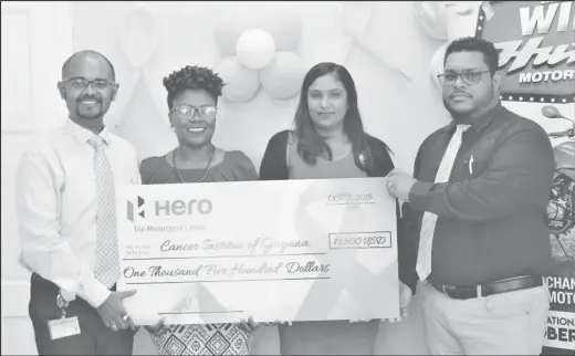  ??  ?? Dr. Sayan Chakrabort­y (left) receives the donation from Deon Williams (right) in the presence of Monette Harry (second left) and Kamla Mohan.