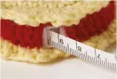  ??  ?? Place the ‘filling’ around the tape measure, then sandwich it between the two biscuits.