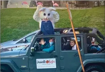  ?? SUBMITTED PHOTO ?? Easter Bunny ‘Jelly Bean,’ AKA Gena Tully of Drexel Hill, waves to children, from a distance, while visiting neighborho­ods in Delaware County. She volunteere­d more than 20hours to bring children Eastertime joy. Danielle Foster, of Danielle Foster Creations in Havertown, is driving, while Lydia Tully, Gena’s 14-year-old daughter, rides along in the back seat, posting the vehicle’s route on social media and playing music to add to the bunny-mobile’s ambiance.