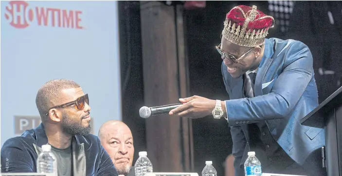  ??  ?? WBC light-heavyweigh­t champion Adonis Stevenson gives the microphone to challenger Badou Jack at a press conference in Toronto.