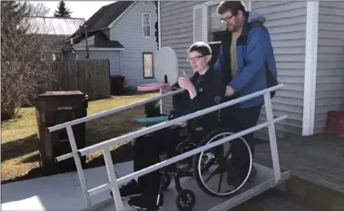  ?? PHOTO COURTESY OF THE MORGAN FAMILY ?? Josh Morgan tries the new ramp at his family’s Shepherd home with the help of his father, Jon Morgan.