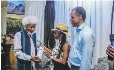  ??  ?? L-R: Wole Soyinka, receiving a specially designed bottle of wine from Vivian Asibelua of Winestitut­e, while Nero Asibelua looks on, at the wine auction marking his 85th birthday in Lagos recently.