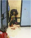  ?? HPD Video ?? Footage from a city jail in 2014 shows Houston police officer Salvador R. Corral handling a detainee by a holding cell door.