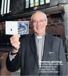  ??  ?? Christmas greetings Rev Alan Birss with the card featuring an image from the Children’s Window