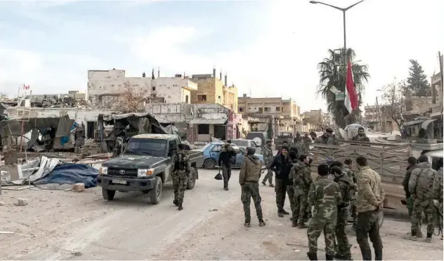  ??  ?? ↑
Syrian army soldiers gather with vehicles in a square in the town of Saraqib on Saturday.
Agence France-presse