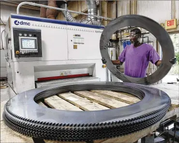  ?? TY GREENLEES / STAFF ?? Thearon Moore operates a deburring machine at Staub Manufactur­ing Solutions in Dayton. Co-owner Steve Staub says the company starts pay at $15 an hour and offers full benefits for entry-level metal-grinding jobs but has had trouble finding workers.