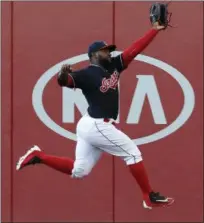  ?? RON SCHWANE — THE ASSOCIATED PRESS ?? The Indians’ Abraham Almonte makes a leaping catch of a drive by the Nationals’ Bryce Harper during the third inning.
