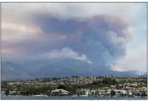  ?? AP/The Orange County Register/KEVIN SULLIVAN ?? Smoke rises Wednesday from a wildfire in the mountains near Mission Viejo, Calif. The blaze consumed mostly unoccupied land, but fire crews feared that it could threaten foothill communitie­s.