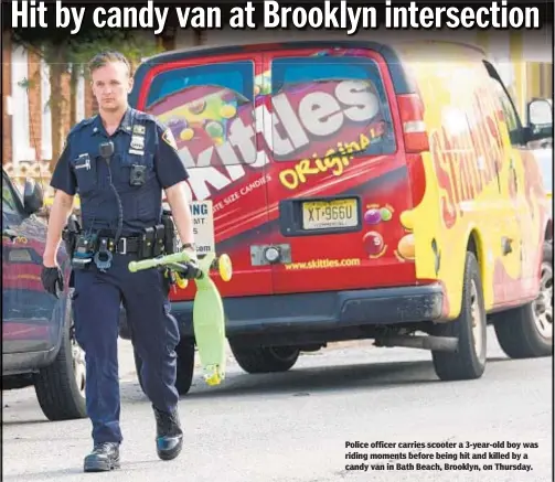  ??  ?? Police officer carries scooter a 3-year-old boy was riding moments before being hit and killed by a candy van in Bath Beach, Brooklyn, on Thursday.