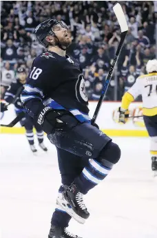  ?? TREVOR HAGAN/THE CANADIAN PRESS ?? Winnipeg Jets centre Bryan Little celebrates after scoring a goal on Nashville Predators goaltender Juuse Saros Sunday in Winnipeg.