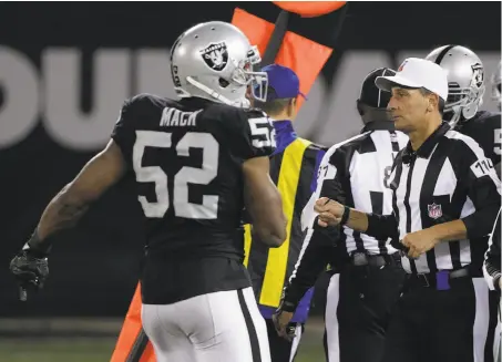  ?? Eric Risberg / Associated Press ?? Referee Gene Steratore (right) disappoint­s the Raiders and Khalil Mack with his paper-thin determinat­ion of a first down.