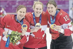  ?? CP PHOTO ?? From left, Canada’s Jayna Hefford, Haley Irwin and Gillian Apps show off their gold medals after defeating Team USA in the women’s gold medal hockey game at the Sochi Winter Olympics in Sochi, Russia in February 2014.