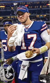  ?? GETTY IMAGES ?? Quarterbac­k Josh Allen celebrates the Bills’ holiday win, 26-15 over the Cowboys, with a turkey leg. Allen says his team is cautiously taking a look at the playoff picture taking shape now, but not forgetting that they must keep winning to get in.