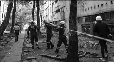  ??  ?? Members of Civil Protection check an apartment building damaged by an earthquake of magnitude 7.4 that struck southern Mexico’s Pacific coast on Tuesday, in Mexico City. (Photo: Reuters)