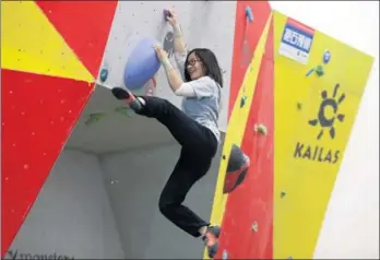  ?? ZOU HONG / CHINA DAILY ?? A woman tries climbing at a sports equipment exhibition in Beijing.