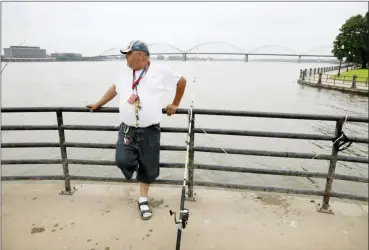  ?? CHARLIE NEIBERGALL — THE ASSOCIATED PRESS ?? William Roelandt fishes on the Mississipp­i River, Tuesday in Davenport, Iowa. Hundreds of communitie­s line the Mississipp­i River, but Davenport is among the few where people can dip their toes into the water without scaling a flood wall or levee.