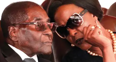 ??  ?? Immune from prosecutio­n: Former Zimbabwe president Robert Mugabe and wife Grace