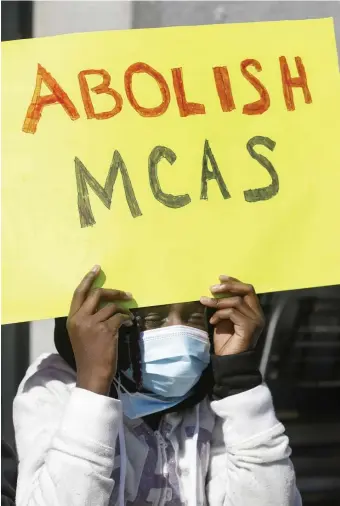  ?? PAUL CONNORS / bOStON HeRALD FILe ?? TEST FOR THE TEST: Elementary school student Jianna Semexant, of Dorchester, holds a sign reading ‘Abolish MCAS’ during an education protest at the State House on March 27.