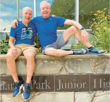  ?? JON BREAM/MINNEAPOLI­S STAR TRIBUNE ?? Tom Edelstein and Larry Bans sit outside Highland Park Junior High School in St. Paul, Minnesota, where they met in 1964. The close friends celebrate their friendship by traveling worldwide to sit on benches.