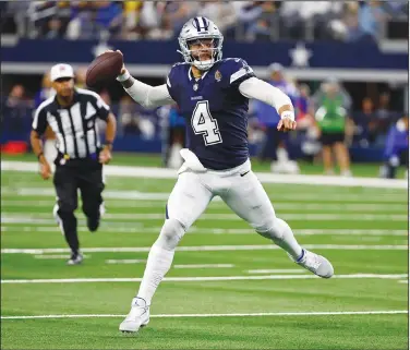  ?? Associated Press ?? Touchdown pass: Dallas Cowboys quarterbac­k Dak Prescott (4) throws a touchdown pass to wide receiver CeeDee Lamb during the first half of an NFL football game against the Los Angeles Rams last Sunday in Arlington, Texas.