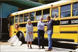  ?? Evan Vucci / Associated Press ?? President Joe Biden, first lady Jill Biden and Kentucky Gov. Andy Beshear, view flood damage on Monday in Lost Creek, Ky., where a bus floated into a building.