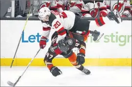  ?? Photograph­s by Jae C. Hong Associated Press ?? ANAHEIM’S HAMPUS LINDHOLM upends New Jersey’s Blake Coleman during the third period of the Ducks’ 4-2 win.