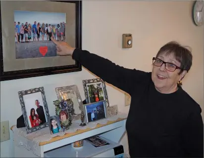  ??  ?? Joseph B. Nadeau photo
Woonsocket’s Sylvia Roark points to photos of her children and grandchild­ren on Saturday, Feb. 29, her 84th birthday. Being a ‘Leap Year Baby,’ Roark has only celebrated 21 times on her actual birth date. Twenty-one candles anyone?