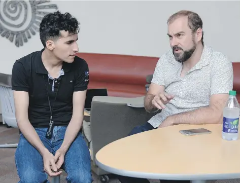  ?? TROY FLEECE ?? Syrian refugee Hany al Moulia, left, and film maker Joel McConvey at the University of Regina in Regina on Tuesday. McConvey is filming a mini-documentar­y about al Moulia, who came to Regina as a Syrian refugee. Hany is legally blind but has a passion...