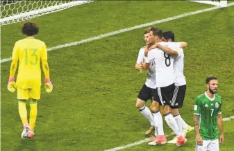  ?? Patrik Stollarz / AFP / Getty Images ?? Germany forward Timo Werner (second from left) celebrates with teammates after scoring on Mexico goalkeeper Guillermo Ochoa during a Confederat­ions Cup semifinal.