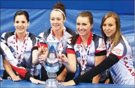  ?? AP PHOTO ?? Canada’s Lisa Weagle (from left), Joanne Courtney, Emma Miskew and Rachel Homan pose with their trophy and medals after winning the world women’s curling championsh­ip.